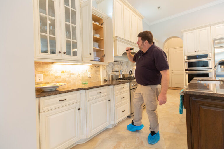 Kevin Reed inspects every inch of the kitchen.