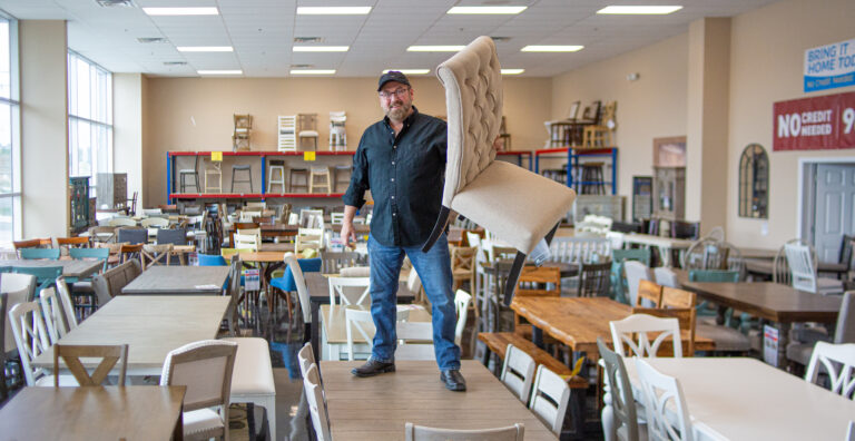 Above, testing a chair in a local furniture store.